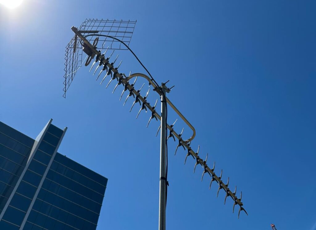 Old analogue TV antenna on Melbourne CBD high-rise building rooftop needing digital upgrade